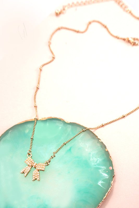 Gold plated pearl bow necklace