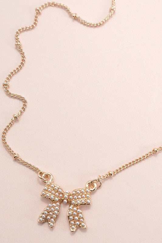 Gold plated pearl bow necklace