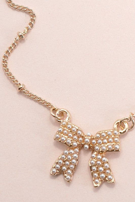 Gold plated pearl bow necklace